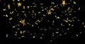 Image of stars floating over confetti on black background Royalty Free Stock Photo