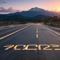 Start 2023 written on highway road in the middle of empty asphalt road of asphalt road at sunset.Concept of planning Royalty Free Stock Photo