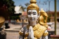 Image of a statue of a girl with a yellow covering in the temple.