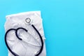 Image of stethoscope and doctor coat over blue background desk. Medical concept Royalty Free Stock Photo