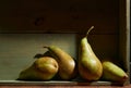 Image of Still Life with a stack of green Pears. Rustic wood background, antique wooden table