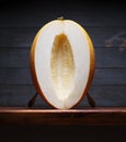 Image of Still Life with yellow Melone. Dark wood background, antique wooden table