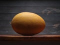 Image of Still Life with yellow Melone. Dark wood background, antique wooden table