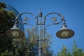 an image of street light on blue sky . vintage lamppost . modern street lamp shines against a background of blue sky at sunset . L Royalty Free Stock Photo