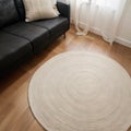 Stylish rug on floor in living room above view