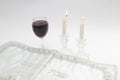 Image subject of Sabbath, a day sacred to the Jewish people. Hand pouring wine cup of sanctification, and Shabbat candles are Royalty Free Stock Photo