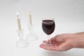 Image subject of Sabbath, a day sacred to the Jewish people. Hand pouring wine cup of sanctification, and Shabbat candles are Royalty Free Stock Photo