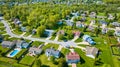 Suburban neighborhoods separated by forest of trees aerial