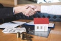 Image of successful deal of real estate, Broker and client shaking hands after signing contract approved application form, Royalty Free Stock Photo