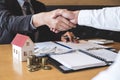 Image of successful deal of real estate, Broker and client shaking hands after signing contract approved application form, Royalty Free Stock Photo