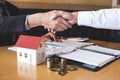 Image of successful deal of real estate, Broker and client shaking hands after signing contract approved application form, Royalty Free Stock Photo