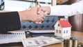 Image of successful deal of real estate, Broker and client shaking hands after signing contract approved application form, Royalty Free Stock Photo