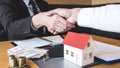 Image of successful deal of real estate, Broker and client shaking hands after signing contract approved application form, Royalty Free Stock Photo