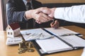 Image of successful deal of real estate, Broker and client shaking hands after signing contract approved application form, Royalty Free Stock Photo