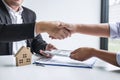 Image of successful deal of real estate, Broker and client shaking hands after signing contract approved application form, Royalty Free Stock Photo