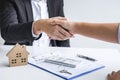 Image of successful deal of real estate, Broker and client shaking hands after signing contract approved application form, Royalty Free Stock Photo