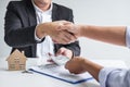 Image of successful deal of real estate, Broker and client shaking hands after signing contract approved application form, Royalty Free Stock Photo