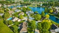 Summer homes next to curving pond with two water fountains neighborhood Royalty Free Stock Photo