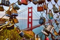 Sunset view Golden Gate Bridge seen through blurry chain link fence with locks Royalty Free Stock Photo