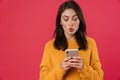 Image of surprised brunette girl using mobile phone Royalty Free Stock Photo