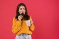 Image of surprised caucasian girl drinking coffee with cookie