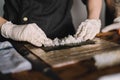 Image of a sushi master preparing a california roll Royalty Free Stock Photo