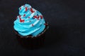 Image of sweet and blue cupcakes on dark table