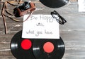 Image of table with records, retro camera, paper and eyeglasses