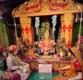 Sclupture of lord Krishna also known as jhule lal on his seat discussing with villagers.