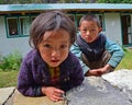 Nepalese kids trying to be friendly in front of their home in a village along Everest Base Camp, Nepal