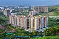 Image of tall buildings under construction near the hill in Pune, Maharashtra.