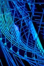 Tangled web of wires of blue LED neon lights with black background
