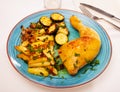 Tasty baked chicken potatoes and zucchini at plate Royalty Free Stock Photo