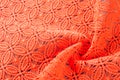 Image texture background, Detail of woven woolen texture of design and lace. Red fabric background. Decorative lace with a patter