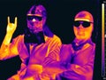 Image in the thermal imager of two people in masks and glasses. Infrared Thermal image people. concept of the coronavirus epidemic Royalty Free Stock Photo