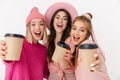 Image of three positive girls smiling and holding takeway coffee cup