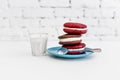 Image of three whoopie pies or moon pies with glass of milk and spoon.