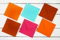 Image of a top view of multi-colored envelopes on a white wooden table. Royalty Free Stock Photo