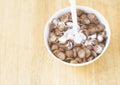 An image top view pouring milk on the cereal chocolate made from corn in the bowl white is a food breakfast a wood table Royalty Free Stock Photo