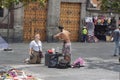 Image of a tourist watching the show of an indigenous in Mexico City