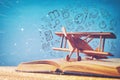 image of toy airplane and book over wooden table with set of back to school infographics