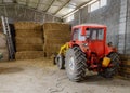 Tractor in a shed with haystacks Royalty Free Stock Photo