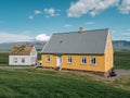 Traditional turf covered house in Glaumbaer, northwestern Iceland. Agricultural fields with horses, and snow-covered mountains in Royalty Free Stock Photo