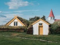 Traditional turf covered house in Glaumbaer, northwestern Iceland. Agricultural fields with horses, and snow-covered mountains in Royalty Free Stock Photo