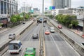 Image of traffic on a road running back and forth in a city in Bangkok.