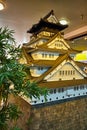 Tree beside artistic rendering of Osaka Castle on hill in Japantown