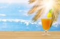 Image of tropical and exotic fruit coctail over wooden table infront of sea landscape background.