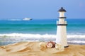 Image of tropical sandy beach, lighthouse and seashells Royalty Free Stock Photo