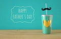 Image of turquoise cup with golden heart. Father`s day concept. Royalty Free Stock Photo