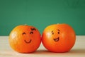 Image of two clementines with drawn smiley faces Royalty Free Stock Photo